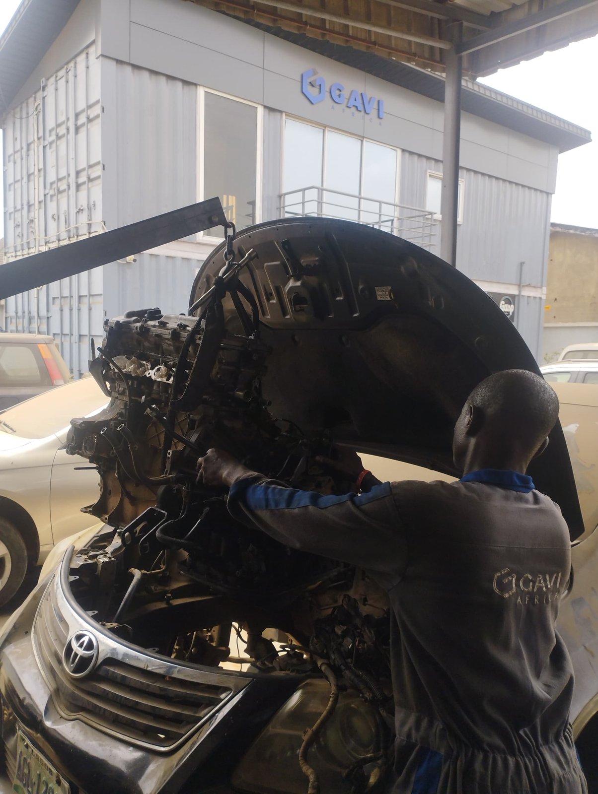 Technician working on an engine removal at the GAVI AFRICA workshop